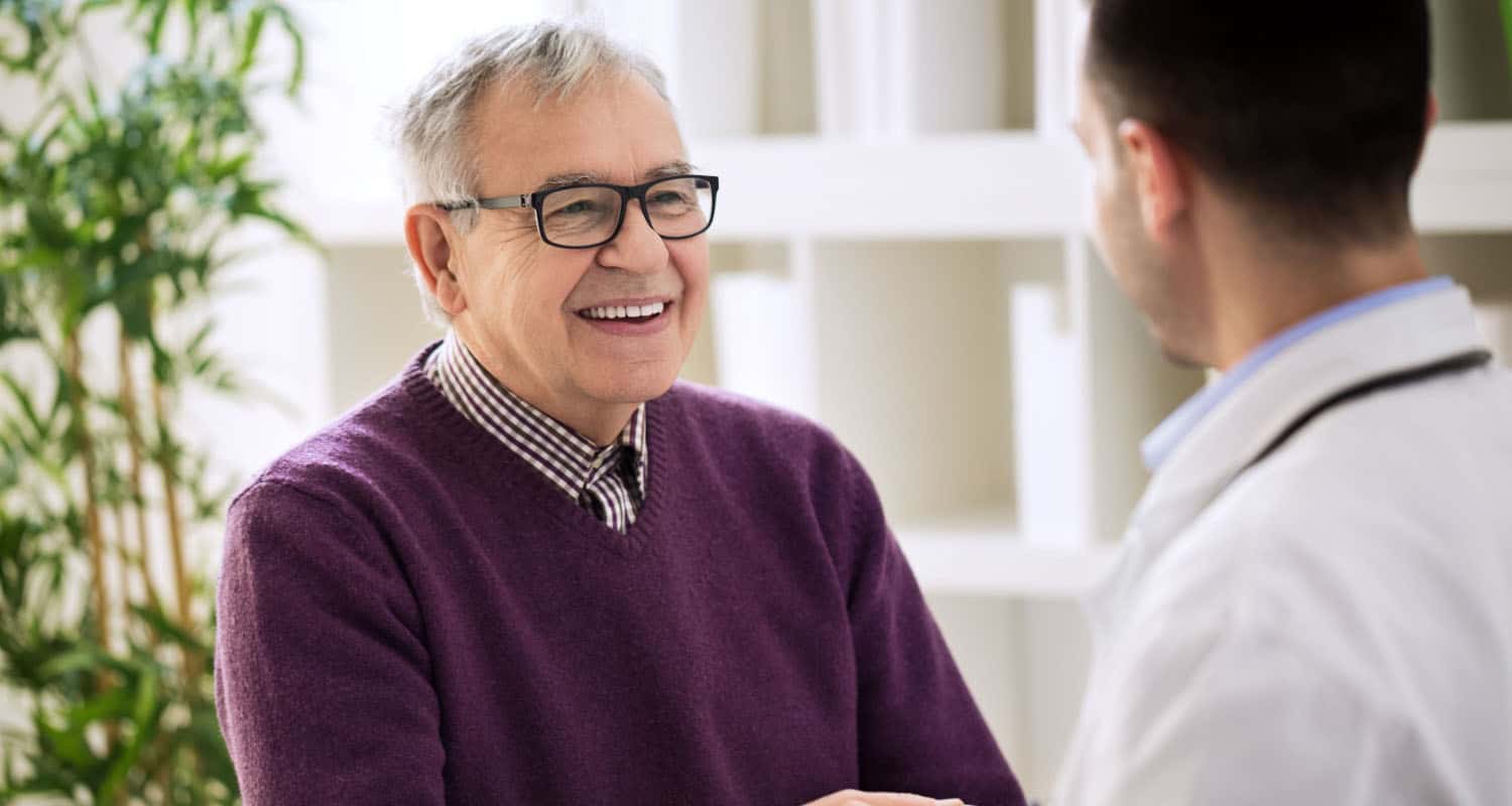 happy male shaking hands with primary care doctor.